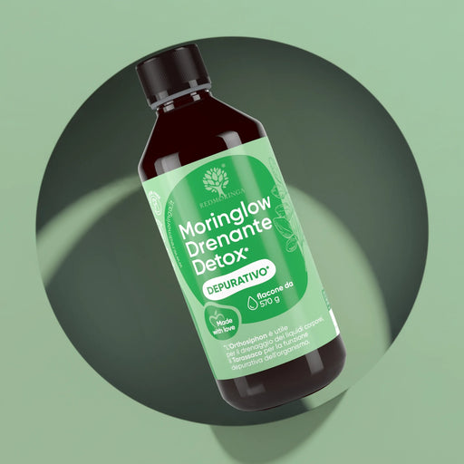 RedMoringa Moringlow Draining Detox, liquid Moringa detox drink, 570 g bottle on a green background