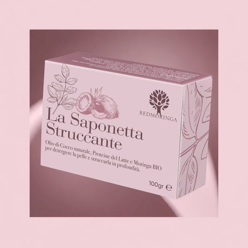 Saponetta struccante viso RedMoringa con olio di cocco, proteine del latte e Moringa bio, confezione da 100 g su fondo rosa
